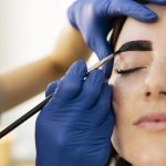 woman-getting-eyebrow-treatment-beauty-salon-scaled.jpg